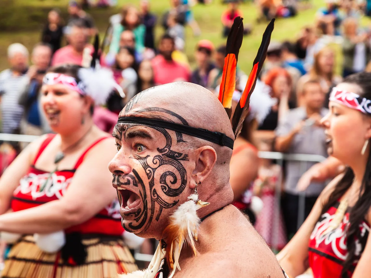 A performer with traditional Māori tā moko during a cultural performance — representative of the art form, not Te Puia's own performers